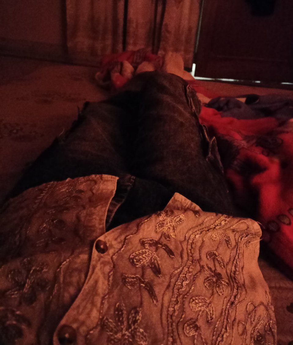 Embroidered traditional outfit laid out on a bed
